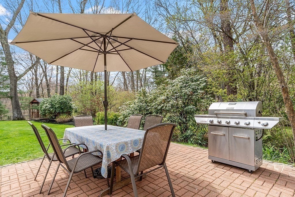 257 Nashoba Road Concord, MA 01742 - Photo 5 of 41 a patio with a patio table and chairs