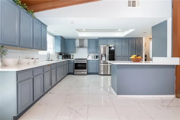a kitchen with stainless steel appliances granite countertop a sink counter space cabinets and a sink