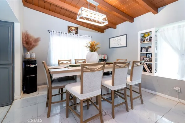 a view of a dining room with furniture and chandelier