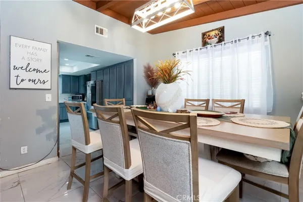 a view of a dining room with furniture and a chandelier