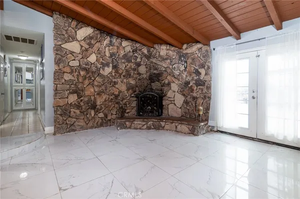 a view of empty room with fireplace