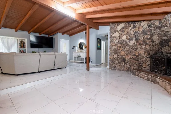 a view of a livingroom with furniture and flat screen tv