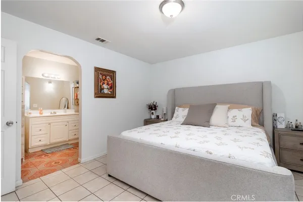 a spacious bedroom with a bed and cabinets