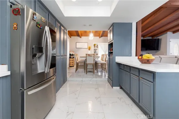 a kitchen with stainless steel appliances a refrigerator and a sink