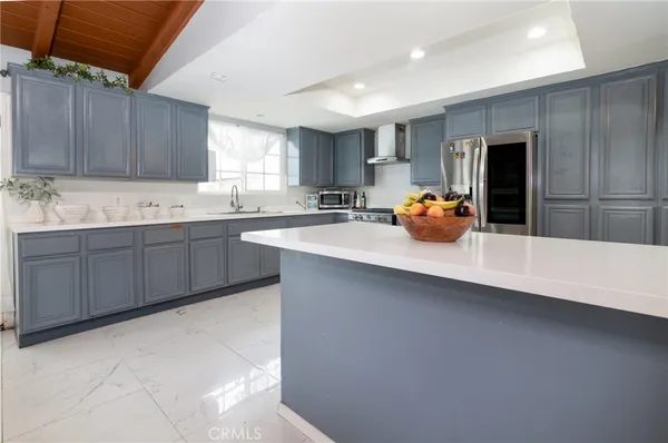 a kitchen with a sink a stove and cabinets