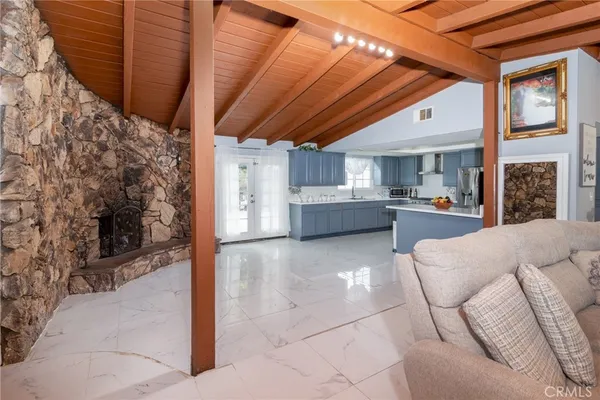a living room with furniture and a kitchen view