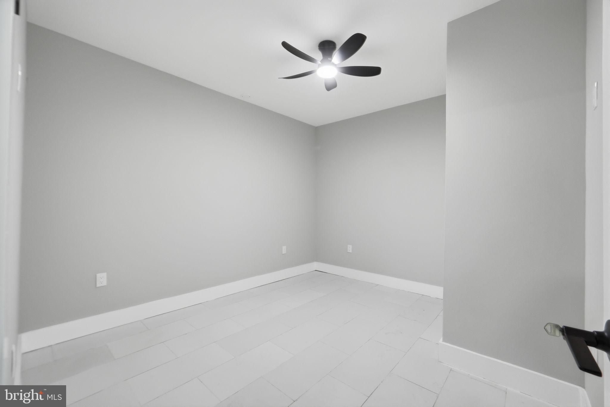 5906 Berwyn Road College Park, MD 20740 - Photo 34 of 46 an empty room with a ceiling fan and a window