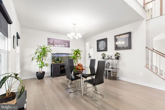 a kitchen that has a lot of white cabinets and stainless steel appliances