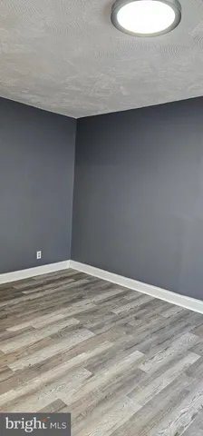 a view of a room with wooden floor and a sink