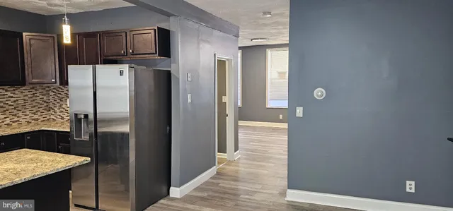 a view of a kitchen from the hallway