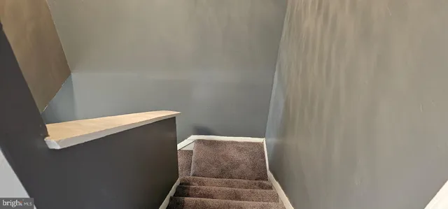 a view of staircase with wooden floor