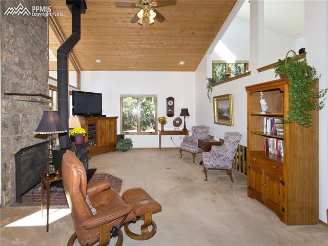 4715 Limestone Road Monument, CO 80132 - Photo 8 of 36 Heart-warming wood stove with beautiful moss rock surround