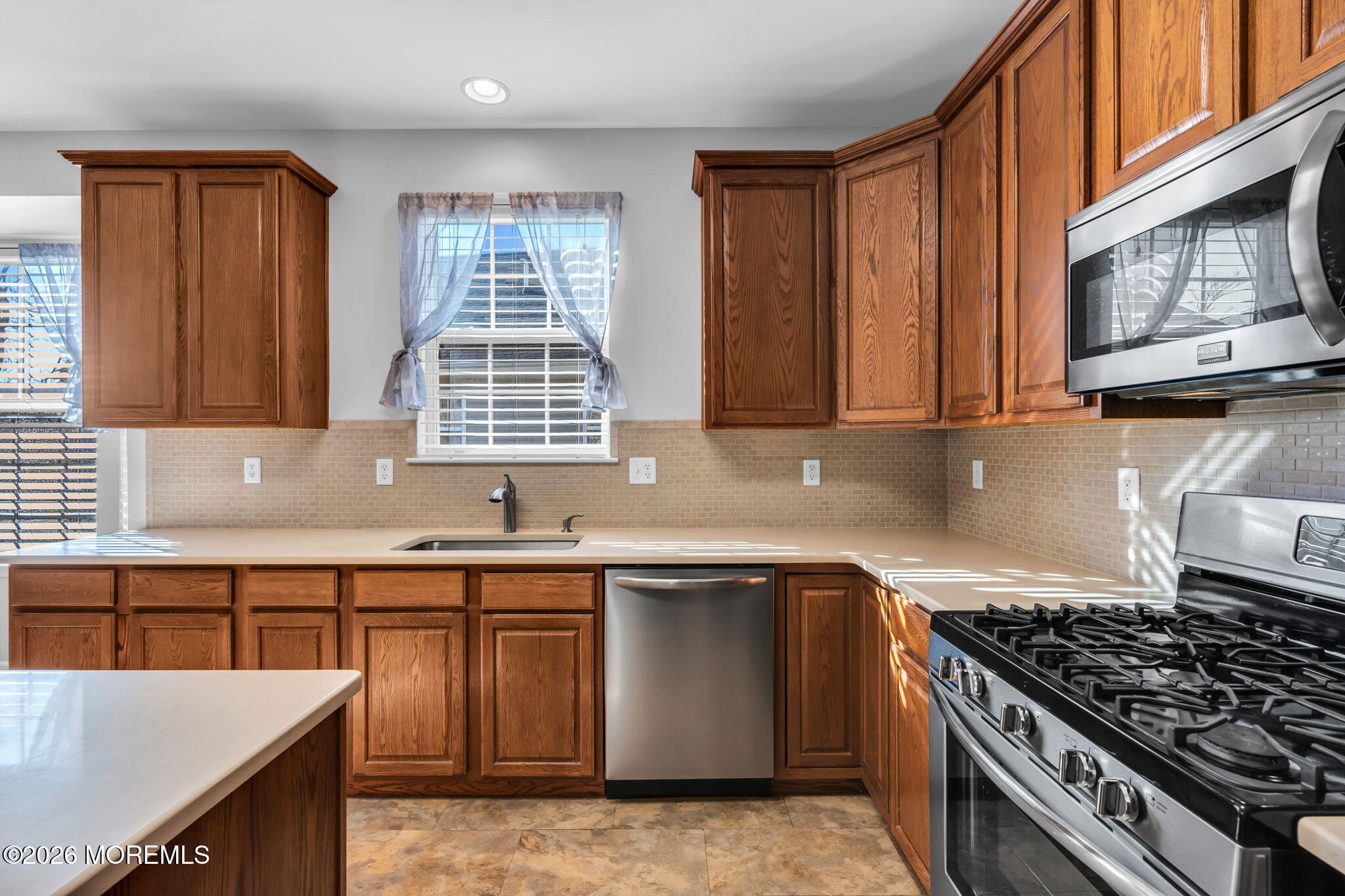 18 Hartack Road Manalapan, NJ 07726 - Photo 11 of 36 a kitchen with stainless steel appliances granite countertop a stove a sink and a microwave
