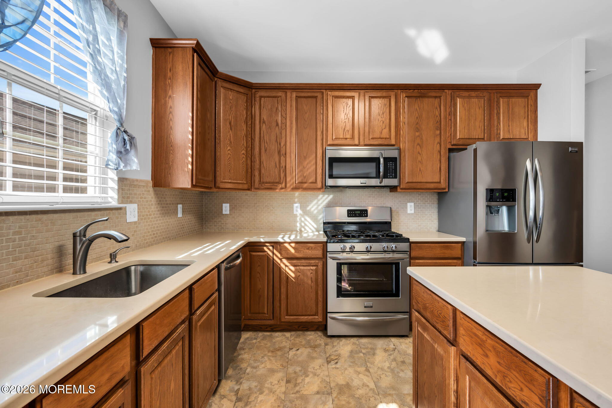 18 Hartack Road Manalapan, NJ 07726 - Photo 13 of 36 a kitchen with stainless steel appliances granite countertop a stove a sink a refrigerator and a microwave