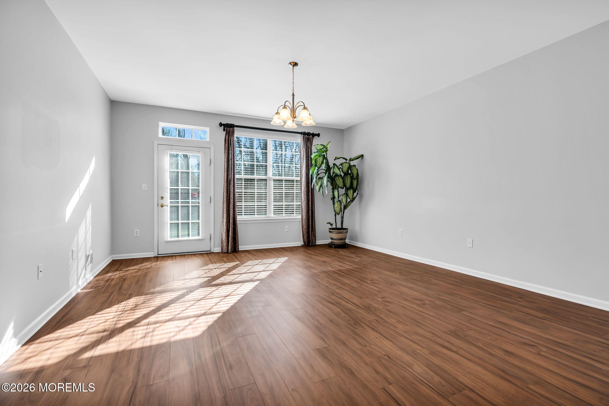 18 Hartack Road Manalapan, NJ 07726 - Photo 18 of 36 an empty room with wooden floor and windows