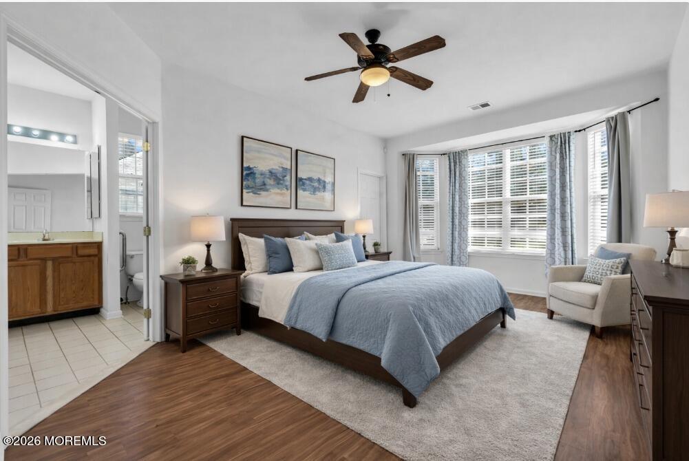 18 Hartack Road Manalapan, NJ 07726 - Photo 20 of 36 a spacious bedroom with a bed a couch and a large window