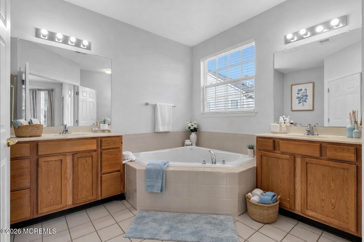 18 Hartack Road Manalapan, NJ 07726 - Photo 25 of 36 a bathroom with a sink a large mirror and a bathtub