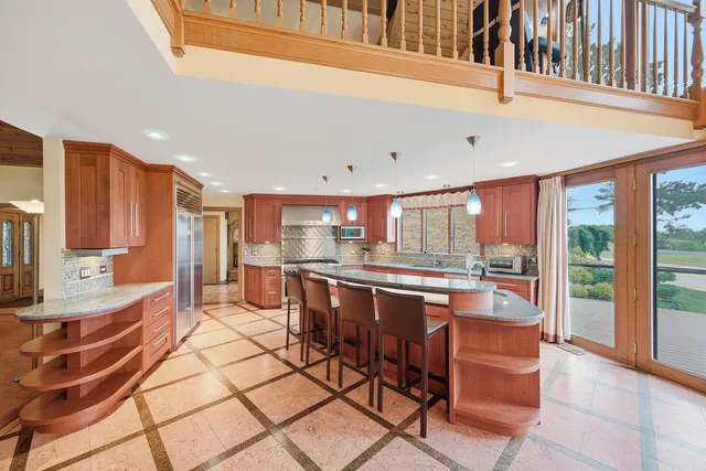a large kitchen with a table and chairs