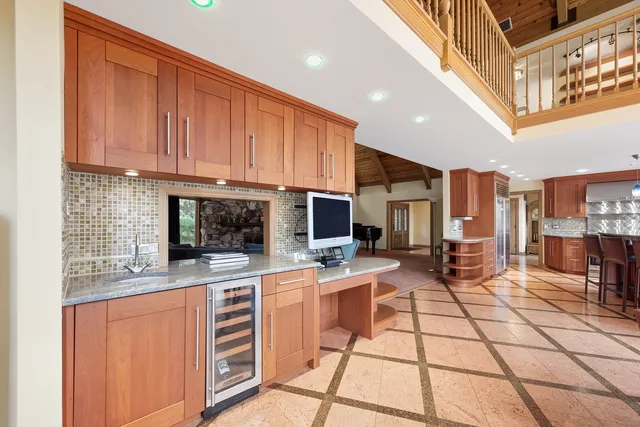 a kitchen with stainless steel appliances kitchen island granite countertop a stove a sink and a microwave