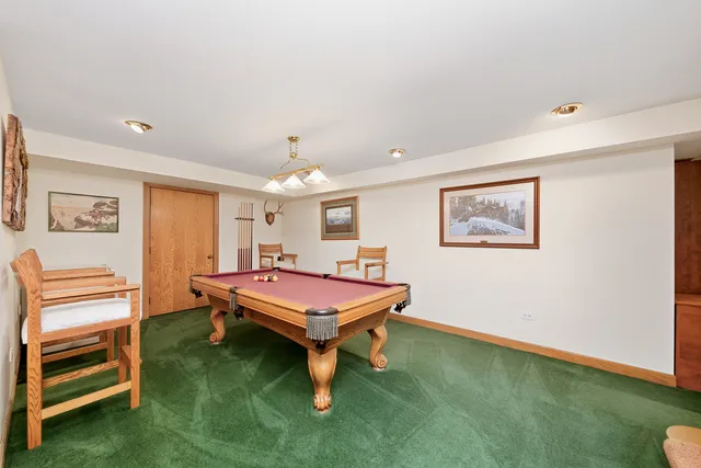 a room with pool table and flat screen tv