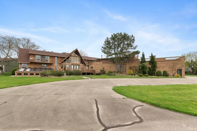 a house with green field in front of it