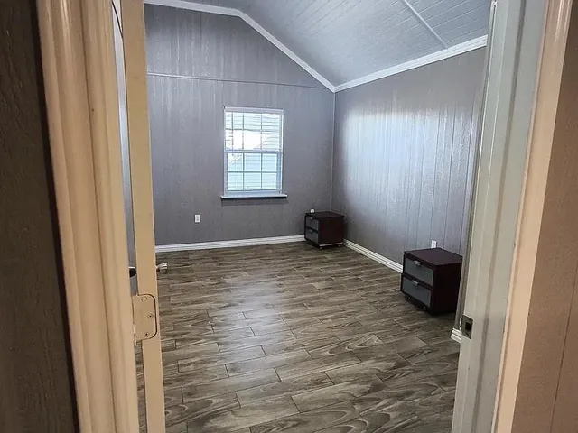 a bathroom with a granite countertop sink a toilet and a mirror