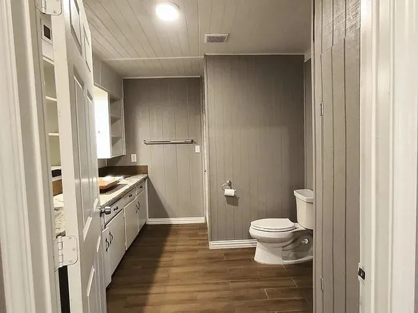 a bathroom with a toilet and a shower