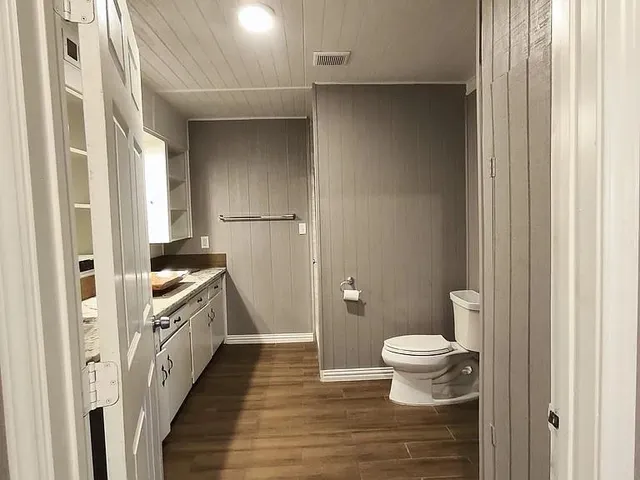 a bathroom with a toilet and a shower