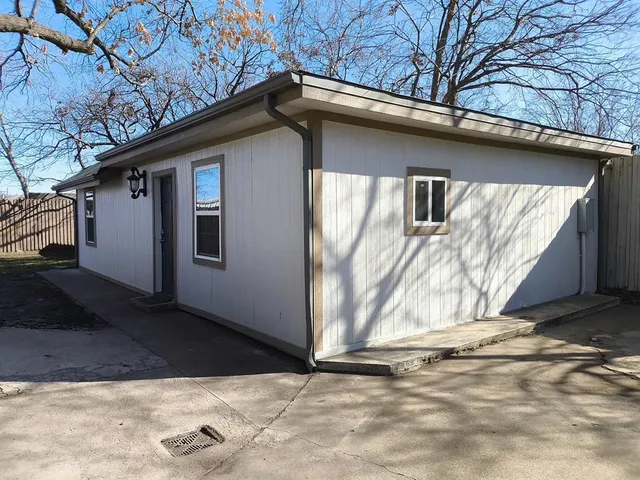 a view of a house with a wooden fence