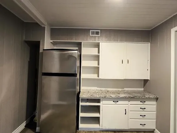 a refrigerator freezer sitting in a kitchen