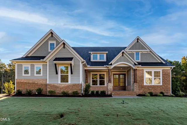a front view of a house with a garden