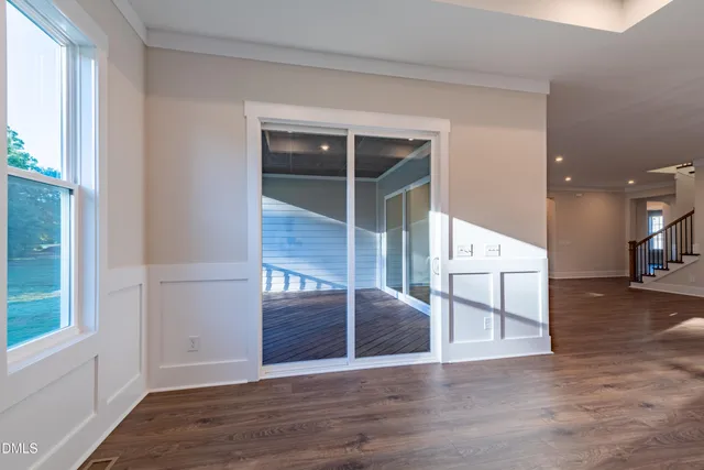a view of kitchen with refrigerator and window