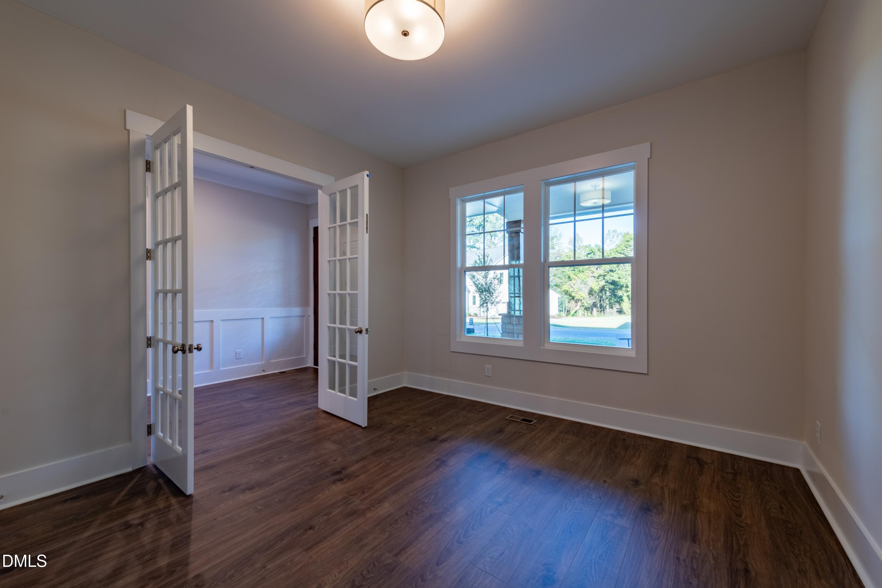 1 Wolf Tree Way Efland, NC 27243 - Photo 11 of 32 an empty room with wooden floor and windows