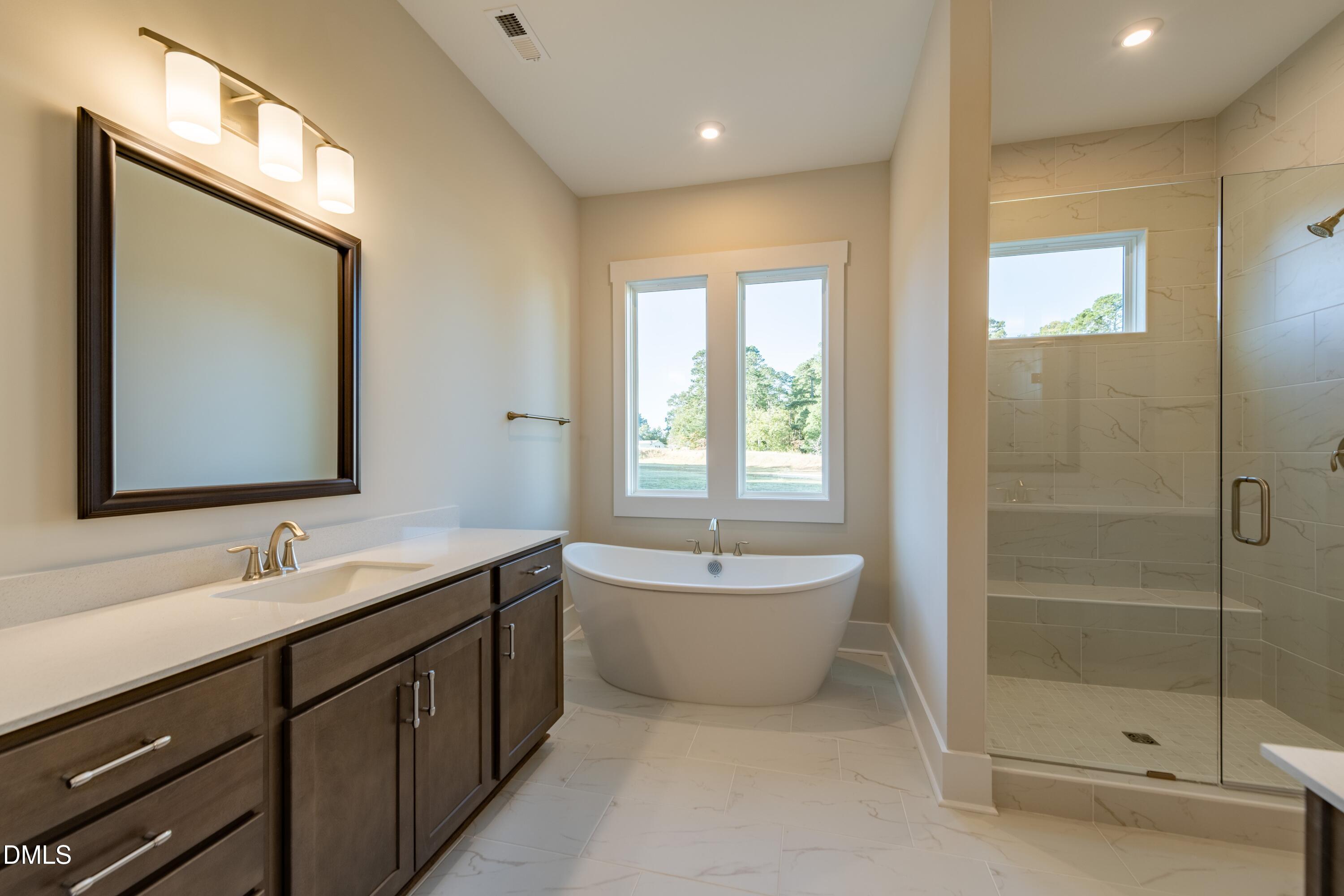 1 Wolf Tree Way Efland, NC 27243 - Photo 15 of 32 a bathroom with a double vanity sink mirror and bathtub