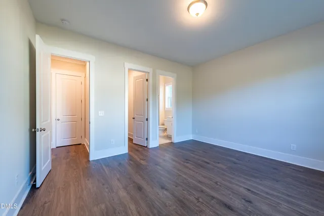 a view of a room with wooden floor and toilet