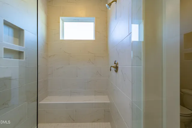 a bathroom with a double vanity sink mirror and bathtub