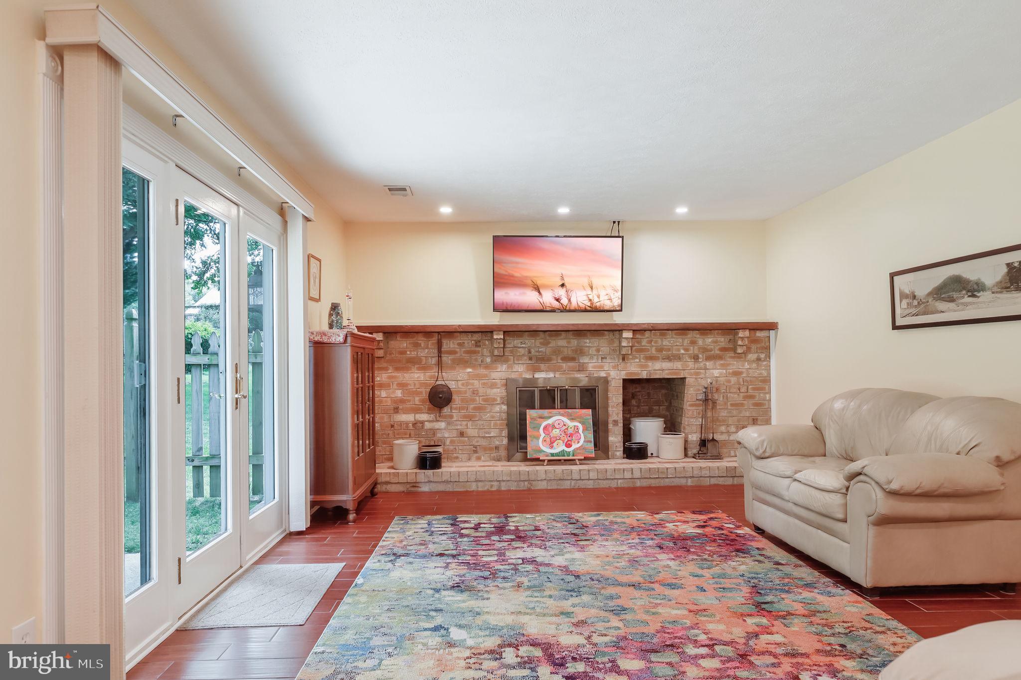 12705 Ruxton Road Silver Spring, MD 20904 - Photo 16 of 44 a living room with furniture and a fireplace