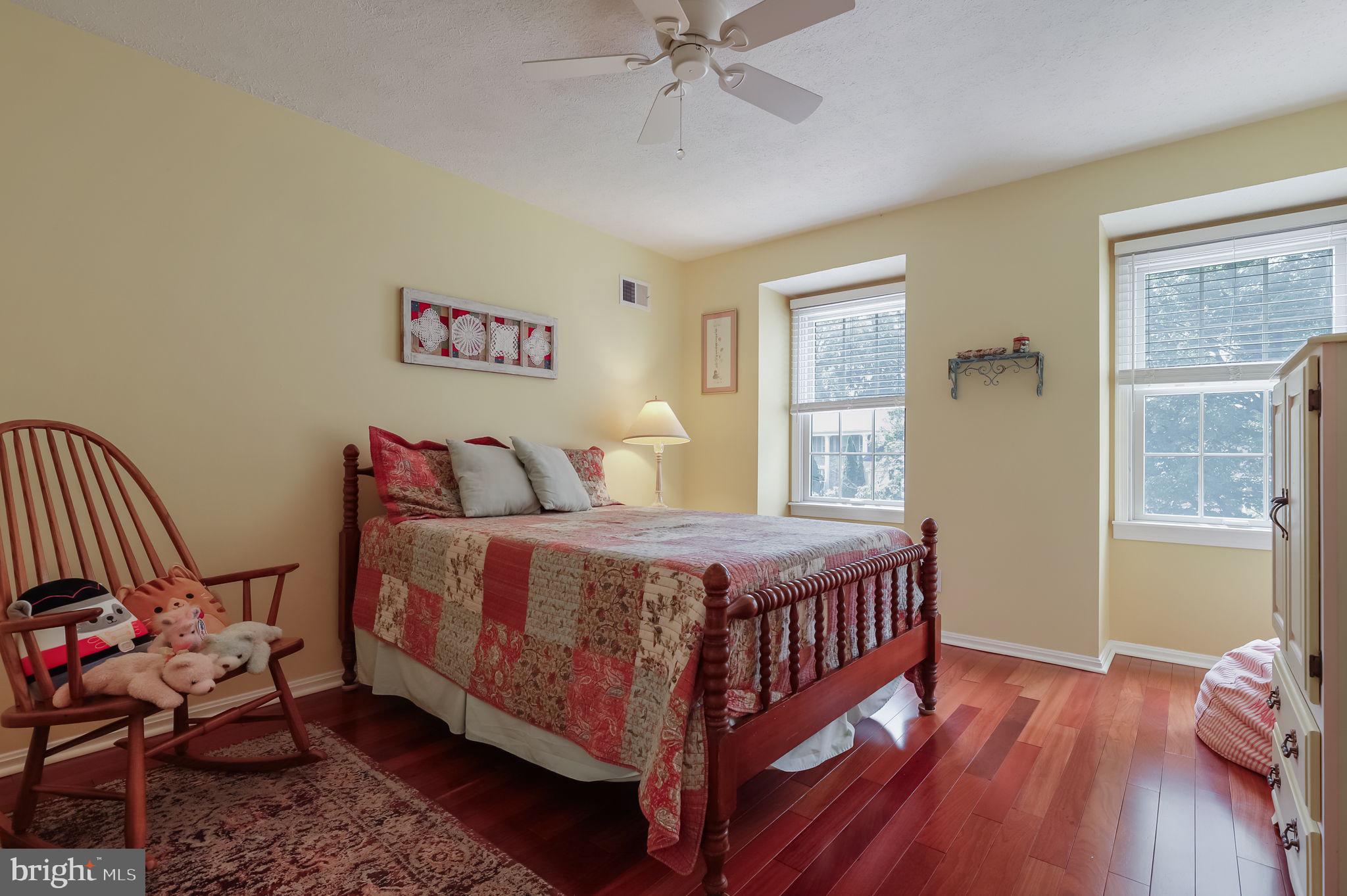 12705 Ruxton Road Silver Spring, MD 20904 - Photo 30 of 44 a bedroom with a bed and wooden floor
