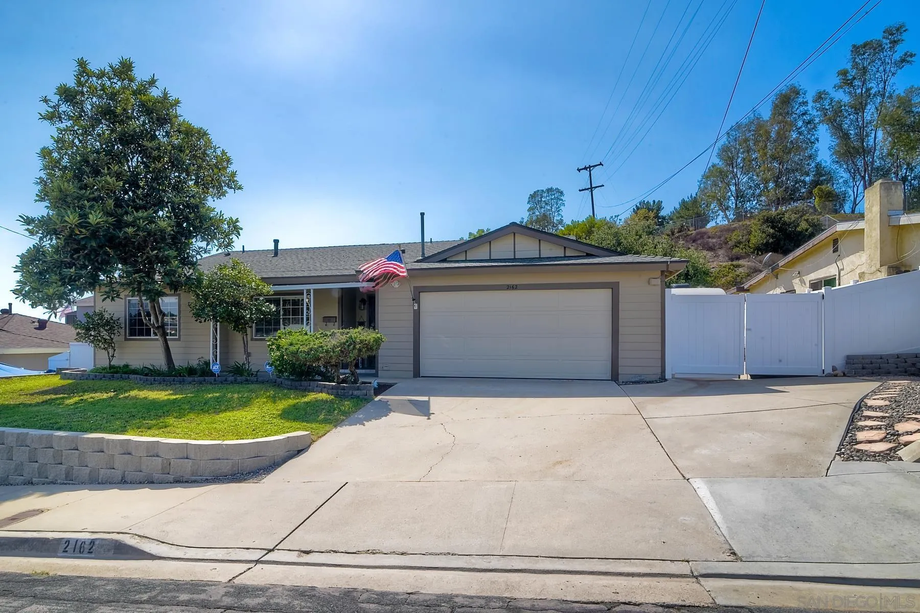 2162 Rising Glen Way San Diego, CA 92139 - Photo 1 of 48 a front view of a house with a yard and garage