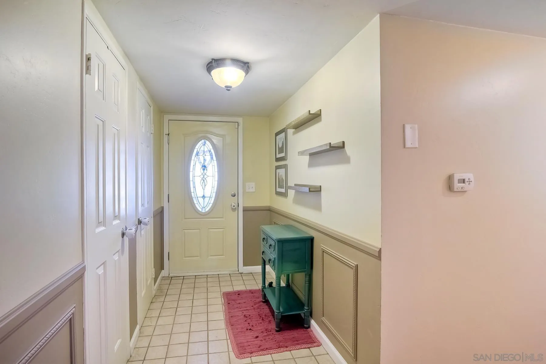 2162 Rising Glen Way San Diego, CA 92139 - Photo 17 of 48 a very nice looking hallway with a large mirror and a window
