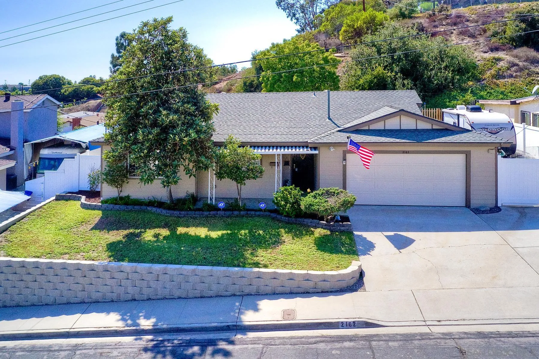 2162 Rising Glen Way San Diego, CA 92139 - Photo 3 of 48 a front view of a house with garden