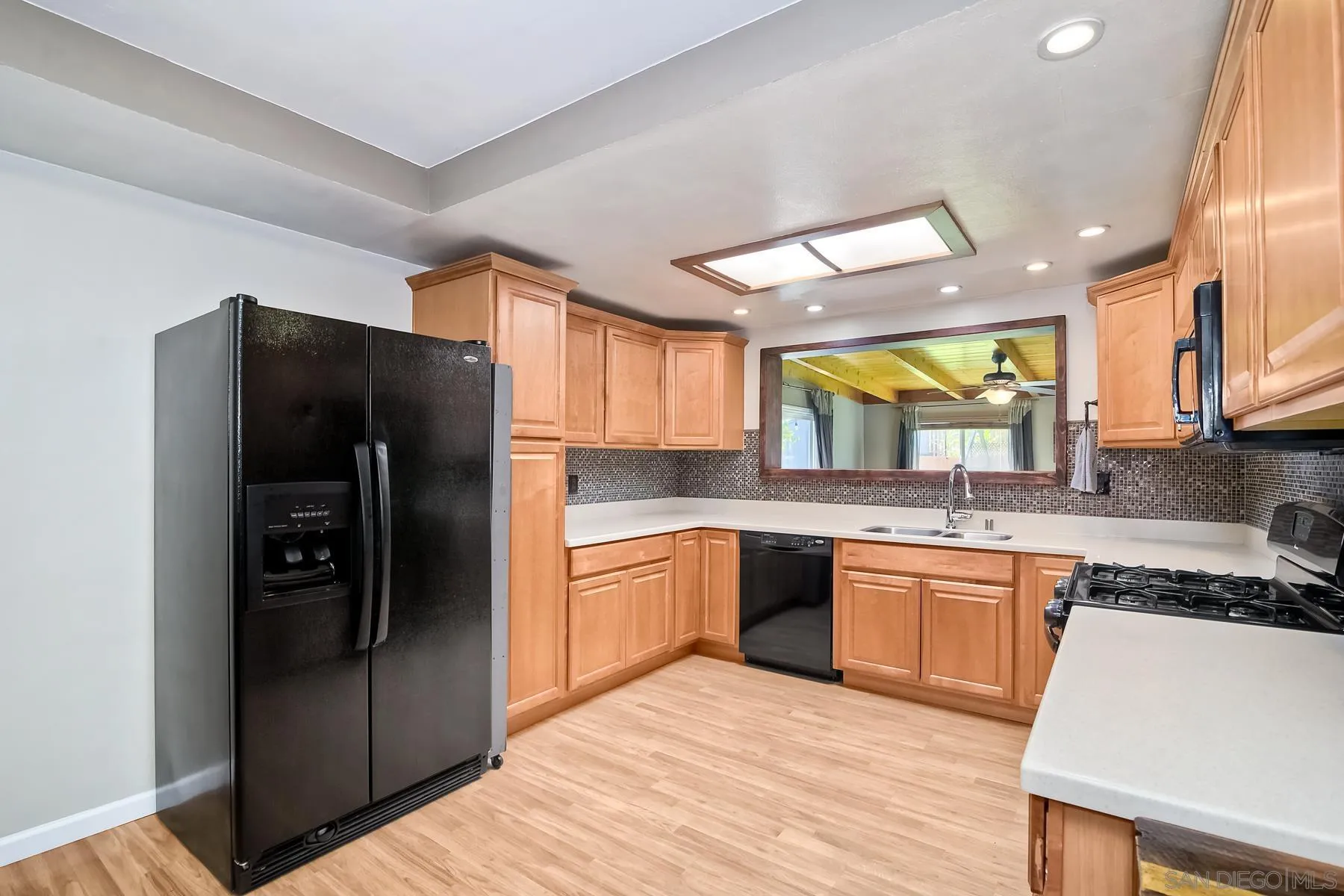 2162 Rising Glen Way San Diego, CA 92139 - Photo 5 of 48 a kitchen with stainless steel appliances granite countertop a refrigerator and a sink