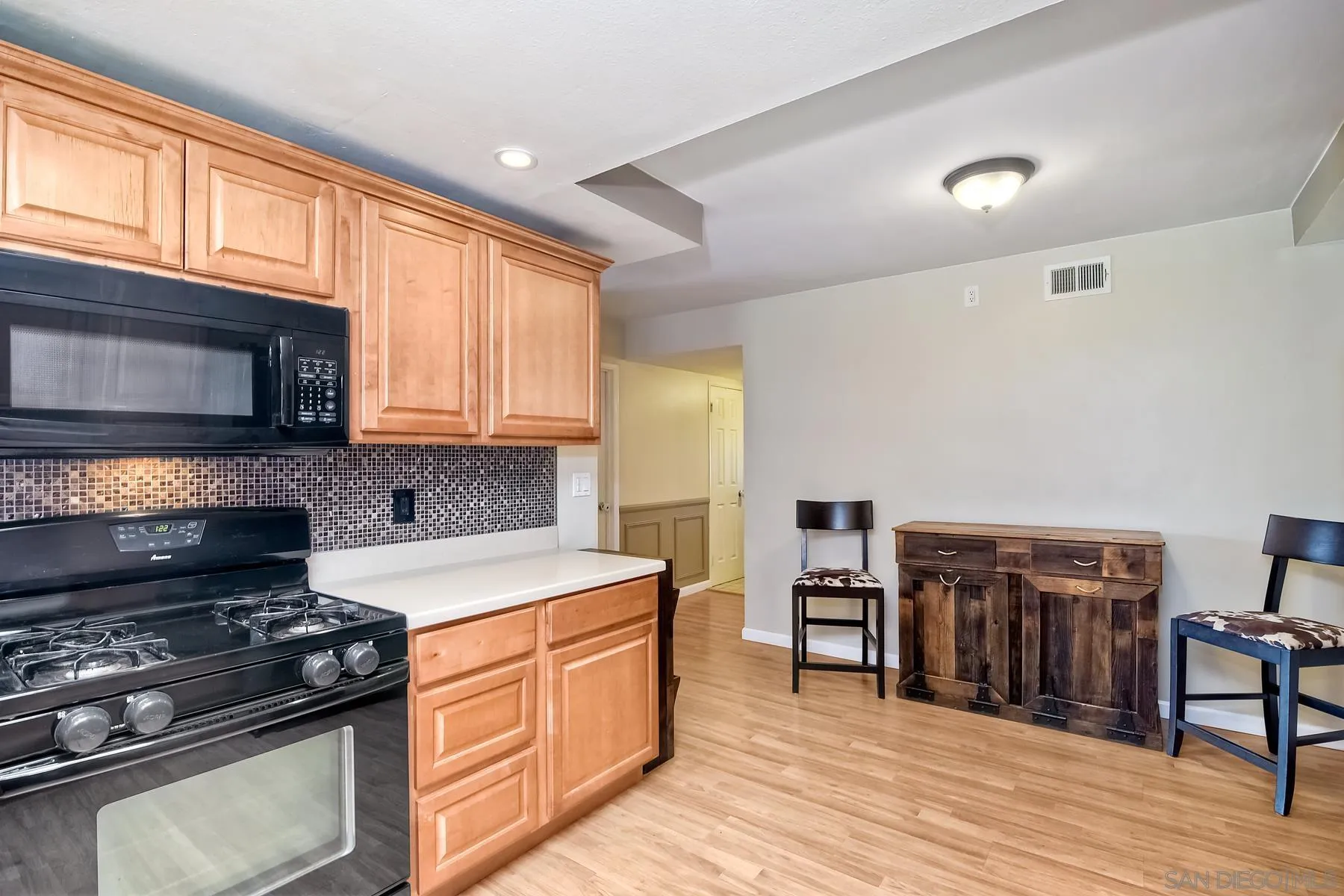 2162 Rising Glen Way San Diego, CA 92139 - Photo 6 of 48 a kitchen with a stove and a microwave
