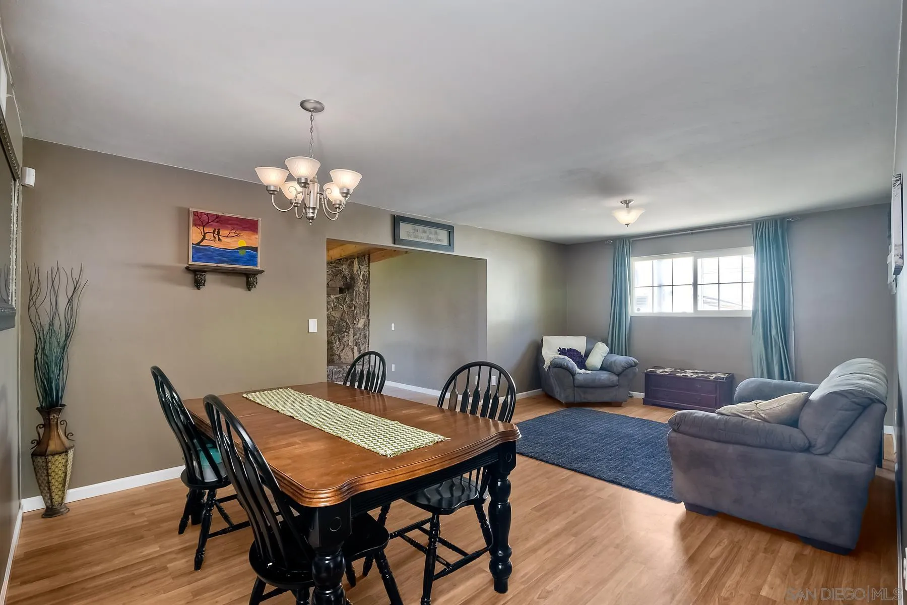 2162 Rising Glen Way San Diego, CA 92139 - Photo 8 of 48 a view of a dining room with furniture and wooden floor