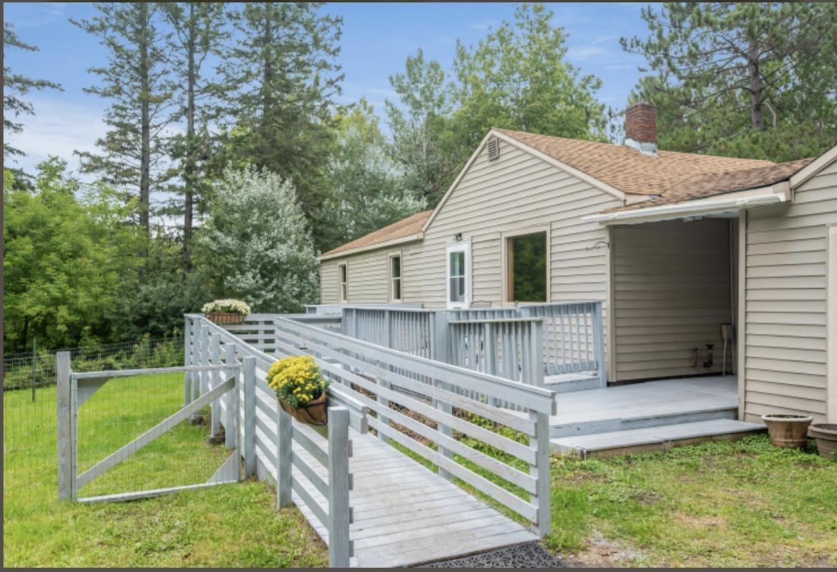 126 Jay Cooke Road Esko, MN 55733 - Photo 1 of 19 Rear view of house with a wooden deck, a chimney, view of wooded area, and roof with shingles
