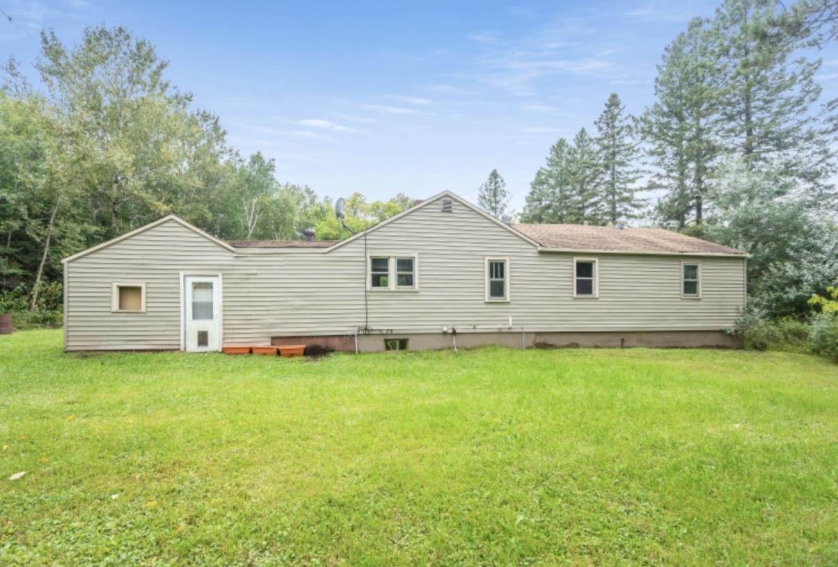 126 Jay Cooke Road Esko, MN 55733 - Photo 18 of 19 Back of house featuring a yard and view of scattered trees