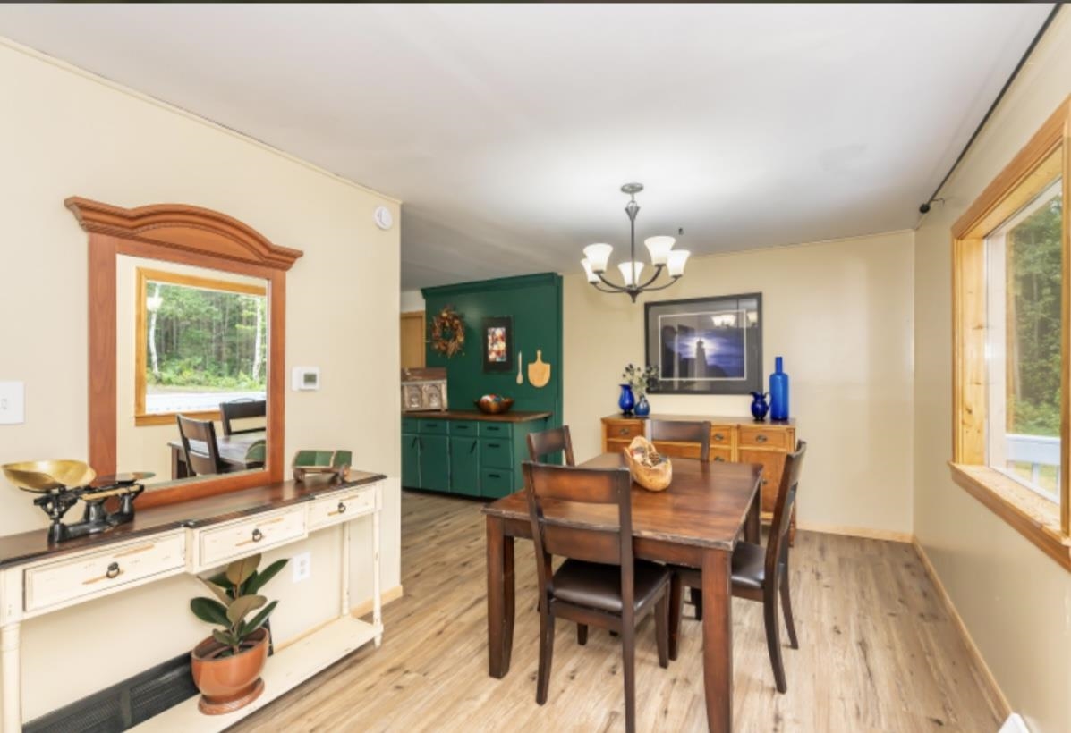 126 Jay Cooke Road Esko, MN 55733 - Photo 4 of 19 Dining room with a chandelier and light wood-style floors