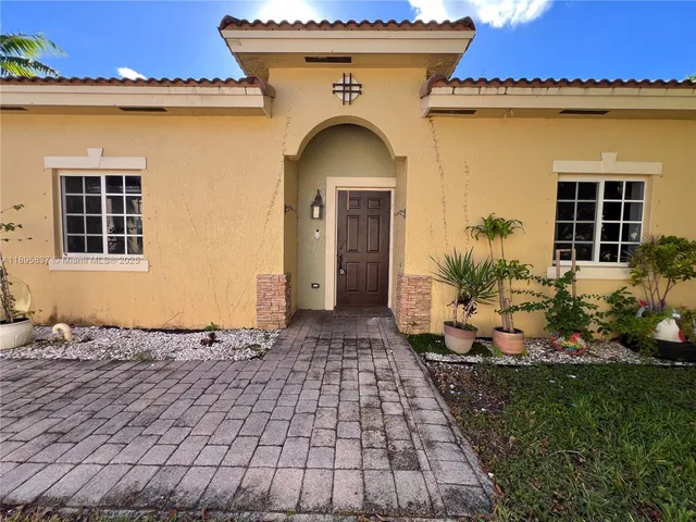 a view of house with car parked beside of road