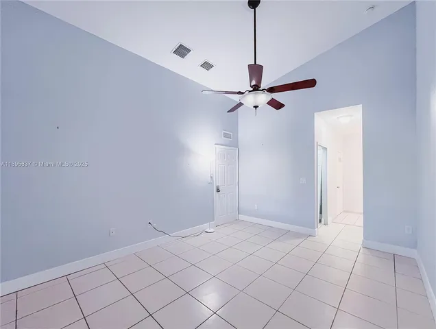 a view of a room with a ceiling fan and a window