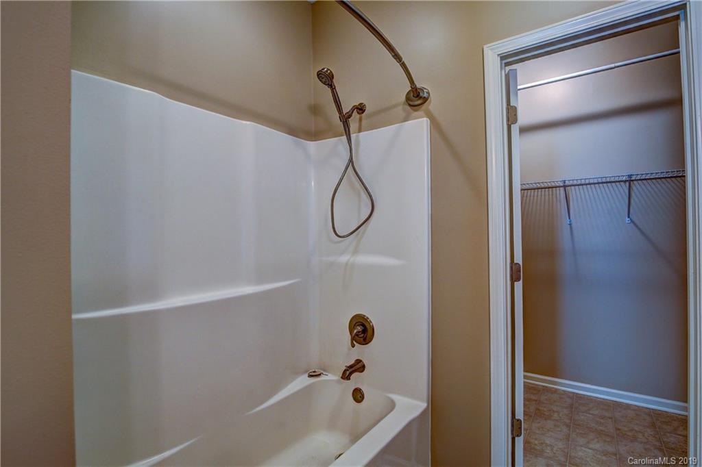 311 Roberdell Road, Unit A/B Rockingham, NC 28379 - Photo 14 of 29 a bathroom with a glass shower door